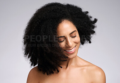 Buy stock photo Happy, natural and hair care shake of black woman satisfied with cosmetic treatment texture and volume. Self love, smile and happiness of african hair and skincare girl in gray studio background.