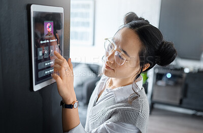 Buy stock photo Music, tablet and Asian woman with digital system in home, apartment and living room. Technology, futuristic design and girl typing song, track and audio on ai software, biometrics and user interface