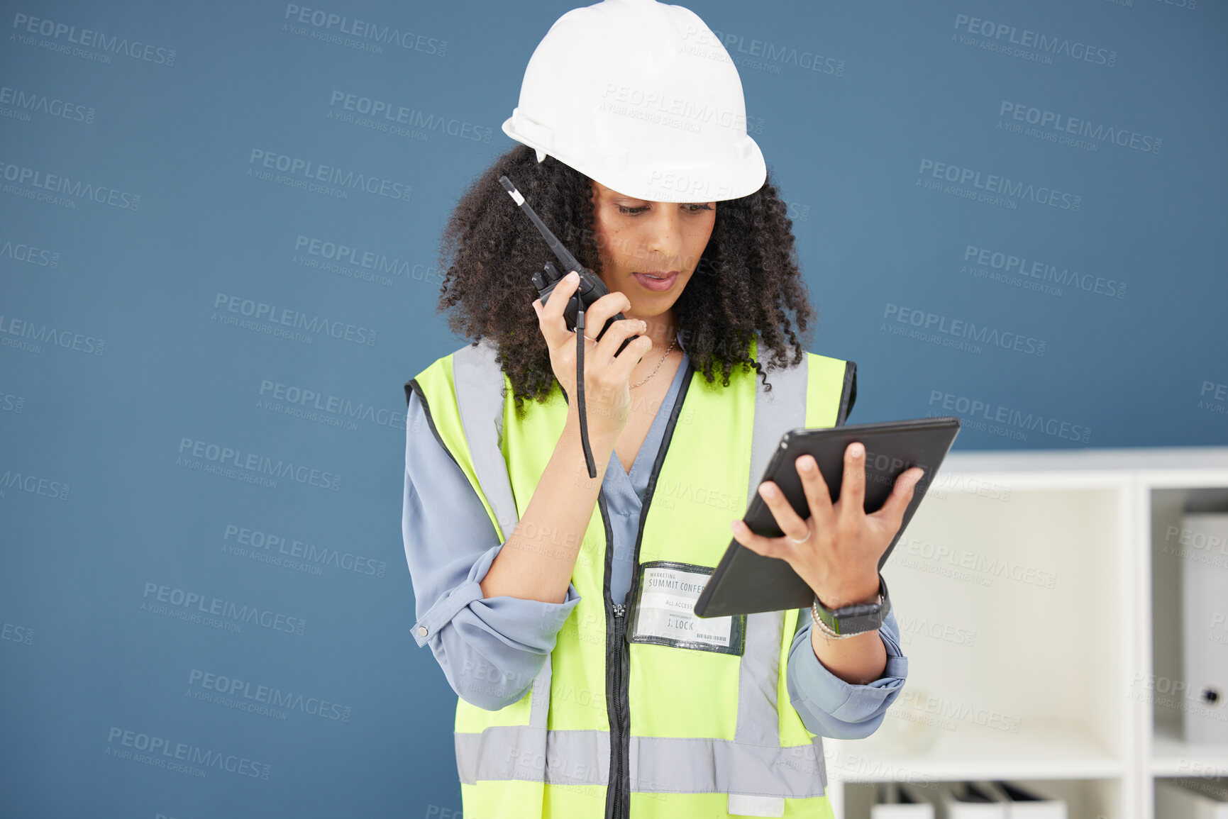 Buy stock photo Radio, tablet and construction with a black woman builder talking over a walkie talkie in her office. Building, internet and safety with a female engineer using communication to manage a build site