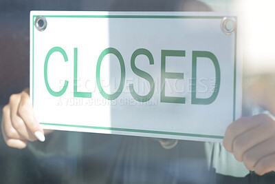 Buy stock photo Closed, sign and window with a small business owner or entrepreneur hanging a signage notice behind closed. Management, store and retail with a woman employee in a shop to hang a poster on a door