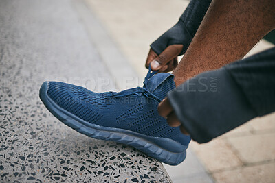 Buy stock photo Hands, city and black man tie shoes and getting ready for running, workout or exercise. Sports fitness, wellness and male runner tying sneaker lace and preparing for training jog on street outdoors.