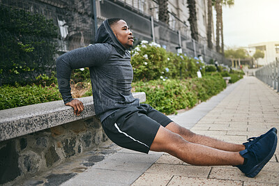 Exercise, triceps dips and black man in city, street or outdoors. Sports, thinking and young male athlete exercising, training and workout for muscle, strength and health, power or body care in town.