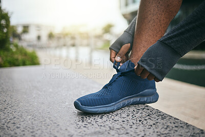 Buy stock photo Hands, fitness and black man tie shoes in city and getting ready for running, workout or exercise. Sports, wellness and male runner tying sneaker lace and preparing for training on street outdoors.