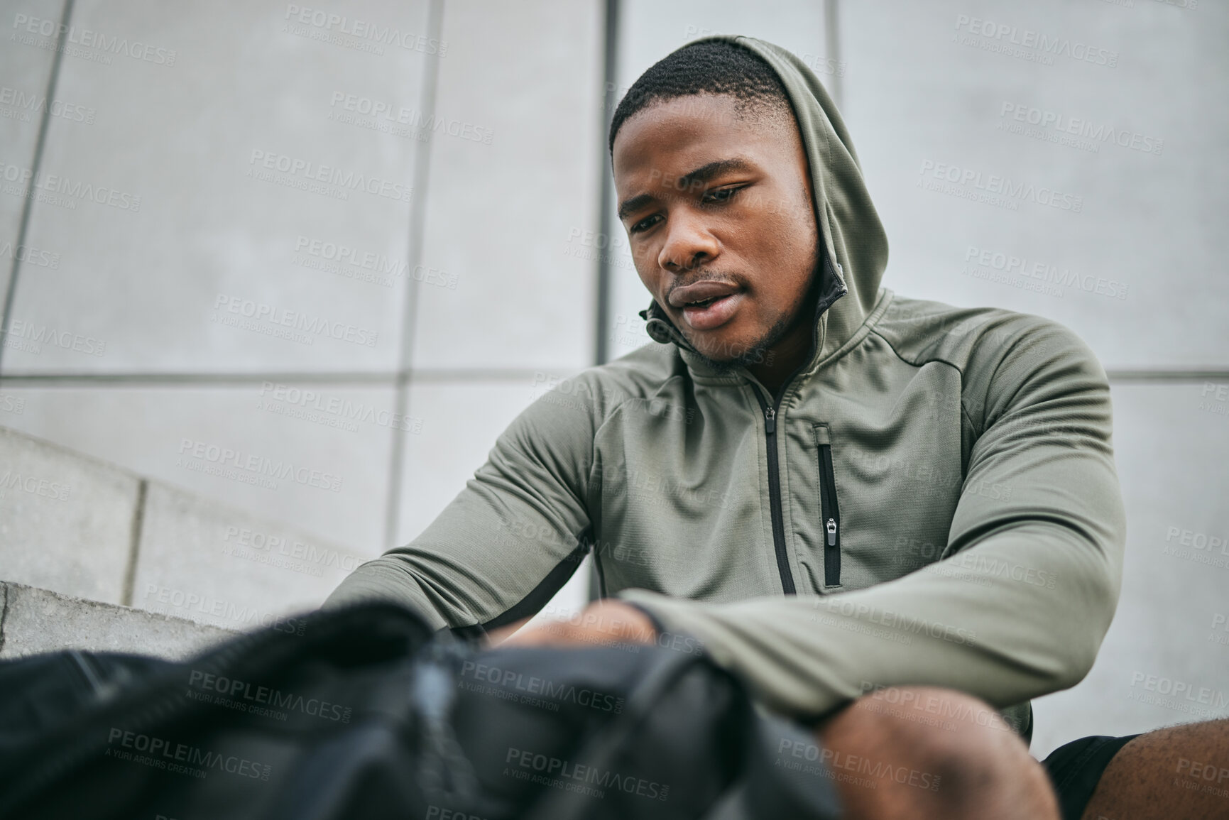 Buy stock photo Fitness, runner and sports bag with a black man athlete taking a break from his exercise in the city. Workout, training and running with a sporty male exercising for sport in an urban town alone