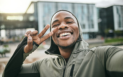 Buy stock photo Fitness, selfie and man with peace sign in the city while doing a cardio exercise in Nigeria. Happy, smile and Nigerian guy taking picture while running for sports, race or marathon training in town.