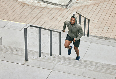 Buy stock photo Runner, fitness and city stairs with a sports black man in the city for a cardio or endurance workout. Training, exercise or motivation with a male athlete running or moving up an urban staricase