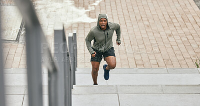 Buy stock photo Fitness, runner or black man running on stairs for training, exercise or cardio workout in Chicago. Mission, mindset or healthy athlete in hoodie with motivation or sports goals exercising on steps