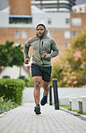 Fitness, exercise and black man running in city in winter for health, wellness and strength. Sports, thinking and male runner exercising, cardio jog or training outdoors alone on street for marathon.