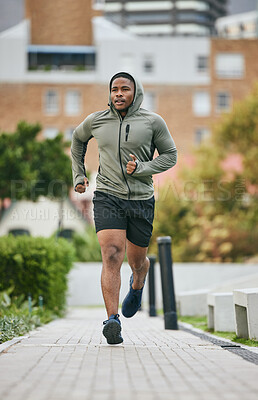 Buy stock photo Fitness, exercise and black man running in city in winter for health, wellness and strength. Sports, thinking and male runner exercising, cardio jog or training outdoors alone on street for marathon.