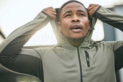 Buy stock photo Fitness, vision and hoodie with a sports black man getting ready for a workout, exercise or running. City, health and goal with a male athlete or runner outdoor in an urban town with motivation