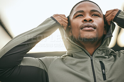 Buy stock photo Exercise, mindset and hoodie with a sports black man getting ready for a workout, fitness or running. City, health and goal with a male athlete or runner outdoor in an urban town with motivation