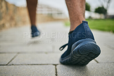 Buy stock photo Running shoes, exercise and fitness with feet of a man outdoor on a pavement for a cardio workout. Athlete runner with sneakers for sports training for health, wellness and a healthy lifestyle