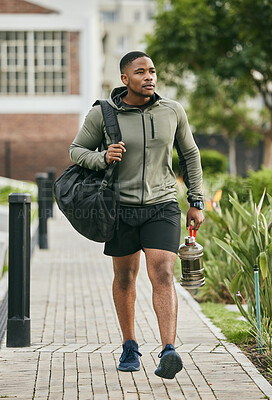 Buy stock photo Fitness, travel or black man walking to gym for body training, exercise or workout with water bottle or gym bag in Atlanta. Path, mindset or healthy sports athlete with wellness goals or motivation 