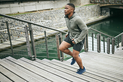 Buy stock photo Fitness, runner or black man running on stairs for legs training, exercise or workout in city of in Miami, Florida. Steps, bridge or healthy sports athlete with wellness goals, motivation or mission 