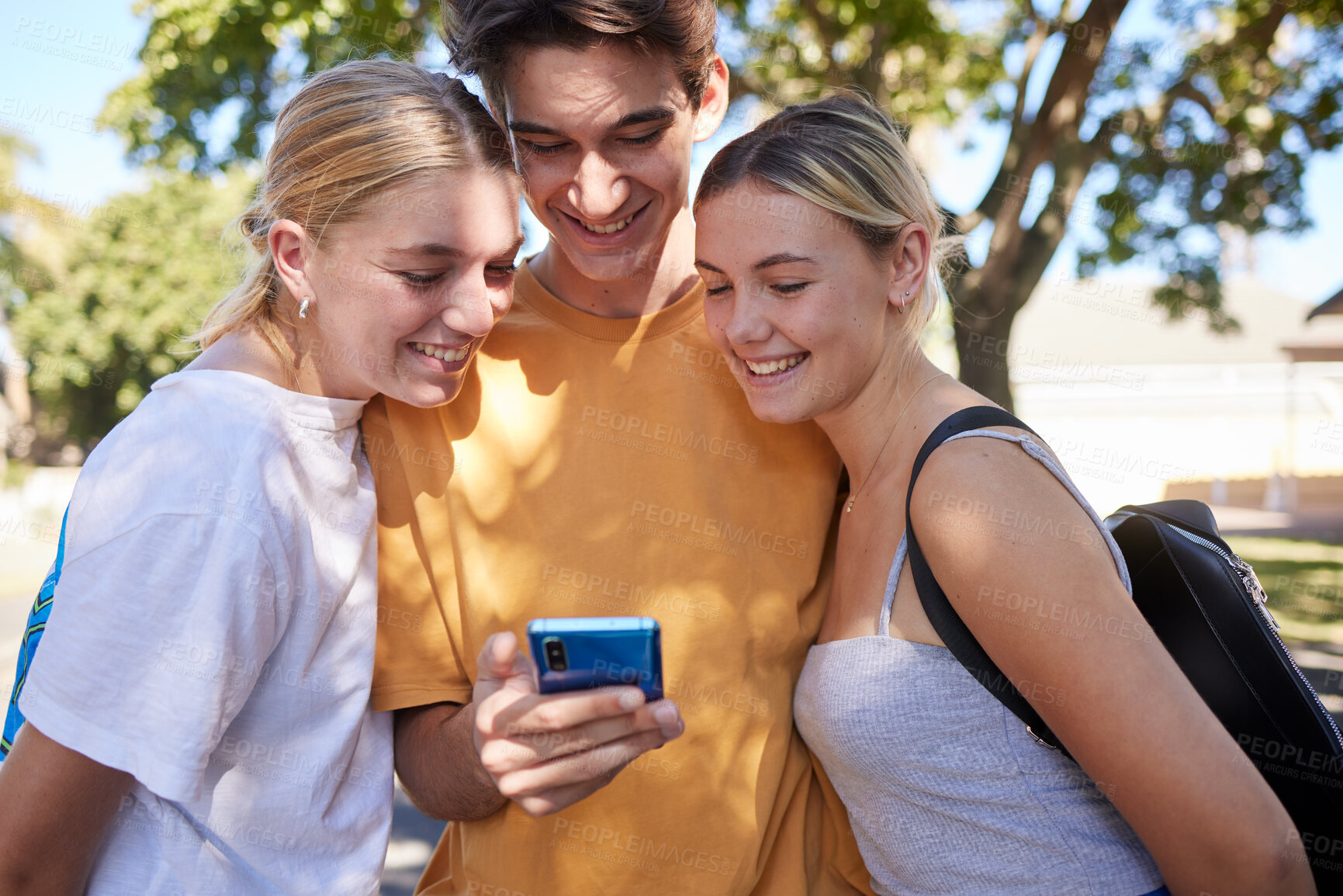 Buy stock photo Phone, friends and social media in a park with a man and woman group reading a text message together outdoor. Mobile 5g technology, communication and friendship with college or university students