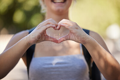 Buy stock photo Hands, woman and heart emoji in nature while outdoor for love, freedom and support for summer travel adventure. Happy young female with hand sign and backpack for motivation, peace and wellness