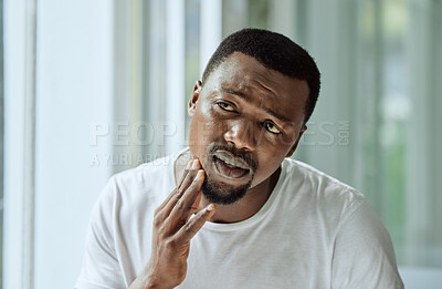 Buy stock photo Sad, aesthetic and anxiety of black man with acne confused with face analysis in home bathroom mirror. Unhappy skincare man checking pimple problem in reflection with morning grooming routine.

