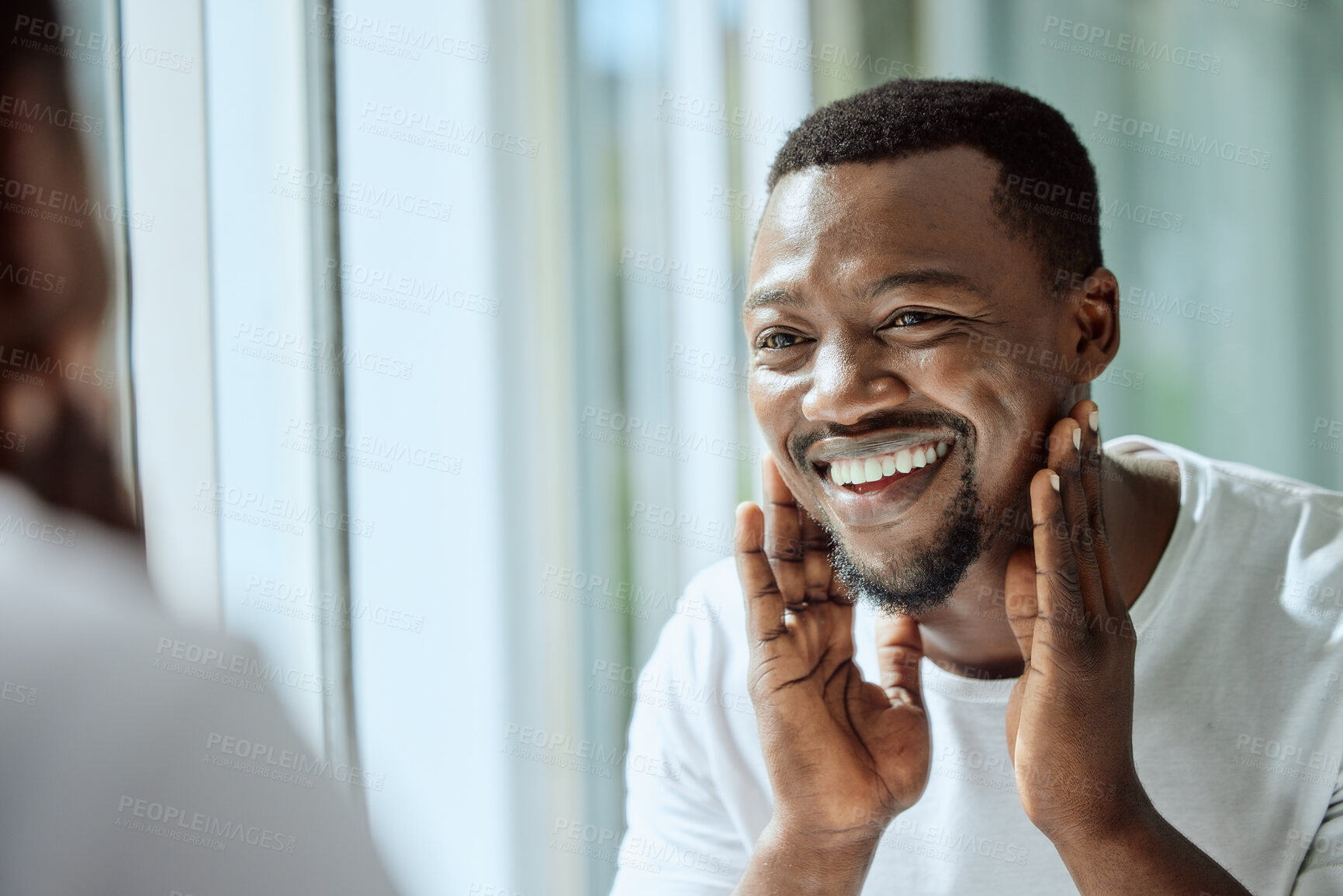 Buy stock photo Beauty, face and skincare with a black man looking in the bathroom mirror during his morning routine at home. Skin, head and reflection with a handsome male grooming for wellness or natural care