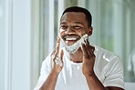 Shaving, cream and black man grooming face for clean look, hygiene care and beauty morning routine in the bathroom. Skincare, happy and African person ready to shave beard and facial hair with foam