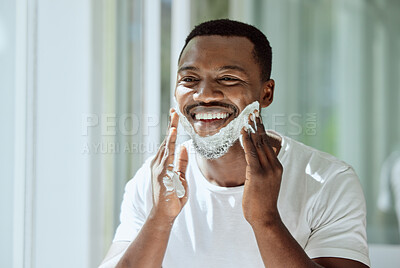 Buy stock photo Shaving, cream and black man grooming face for clean look, hygiene care and beauty morning routine in the bathroom. Skincare, happy and African person ready to shave beard and facial hair with foam