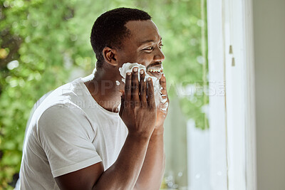 Buy stock photo Beard, cream and shaving black man in the morning, beauty grooming and hair removal in a home bathroom. Skincare, cosmetic and happy African person applying foam to face for clean facial hair shave