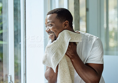 Buy stock photo Black man, skincare and towel after washing face in home bathroom for clean and healthy skin with dermatology. Male happy after a facial, shower or cleaning body with water for hygiene and wellness