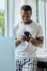 Bathroom, phone and black man in home on social media, texting or internet browsing. Cellphone, relax or happy male holding mobile smartphone for web scrolling, networking or messaging alone in house