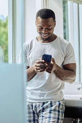 Buy stock photo Bathroom, phone and black man in home on social media, texting or internet browsing. Cellphone, relax or happy male holding mobile smartphone for web scrolling, networking or messaging alone in house