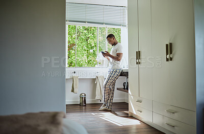 Buy stock photo Phone, bathroom and black man in home on social media, texting or internet browsing. Relax, cellphone or happy male holding mobile smartphone for web scrolling, networking or messaging alone in house
