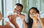Brushing teeth, dental and oral hygiene with a black couple grooming together in the bathroom of their home. Health, tooth care and cleaning with a man and woman bonding during their morning routine