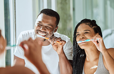 Buy stock photo Brushing teeth, dental and oral hygiene with a black couple grooming together in the bathroom of their home. Health, tooth care and cleaning with a man and woman bonding during their morning routine