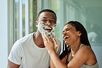 Skincare wellness, happy couple in bathroom and shaving face with product for facial treatment. Laughing together in home, natural beauty and funny girlfriend helping black man with cream application