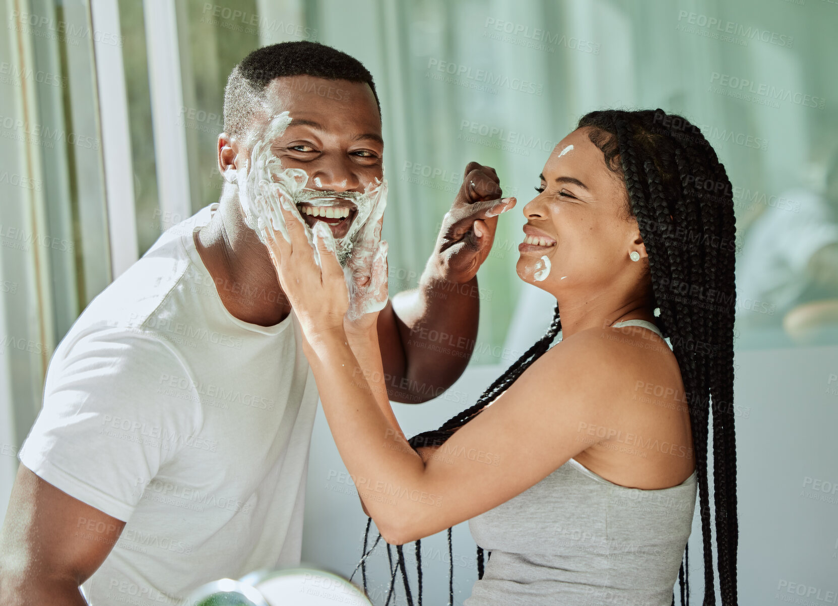 Buy stock photo Shaving, playful and fun with a black couple laughing or joking together in the bathroom of their home. Love, shave and laughter with a man and woman being funny while bonding in the morning