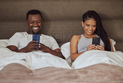 Buy stock photo Black couple, smartphone and happiness together in bed for social media streaming, relax quality time or reading online. African man smile, black woman and happy watching video on phone in bedroom