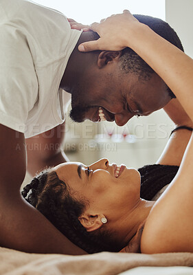 Buy stock photo Black couple, love and home bedroom romance while happy  and intimate together on bed at home, apartment or hotel. Face of young man and woman in happy marriage with commitment and care on honeymoon