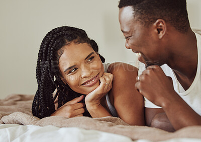 Buy stock photo Black couple, love and bedroom conversation while happy together on a bed in a house, apartment or hotel. Face of young man and woman in a healthy marriage with communication, understanding and care