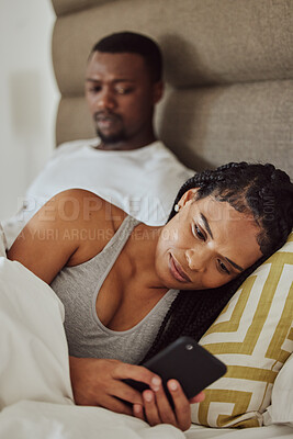 Buy stock photo Couple in bed, black woman with smartphone and nosy man, cheating and suspicion for affair, unfaithful and infidelity. Partners in bedroom, male and female with cellphone, chatting and jealous guy