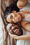 Black couple, love and bedroom selfie while happy and funny together with tongue out on bed at home, apartment or hotel. Portrait of a young man and woman in a happy marriage with commitment and care