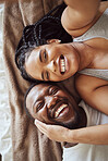 Selfie, love and black couple in bedroom while happy and funny together laughing on bed at home, apartment or hotel. Portrait of a young man and woman in a happy marriage with commitment and a smile