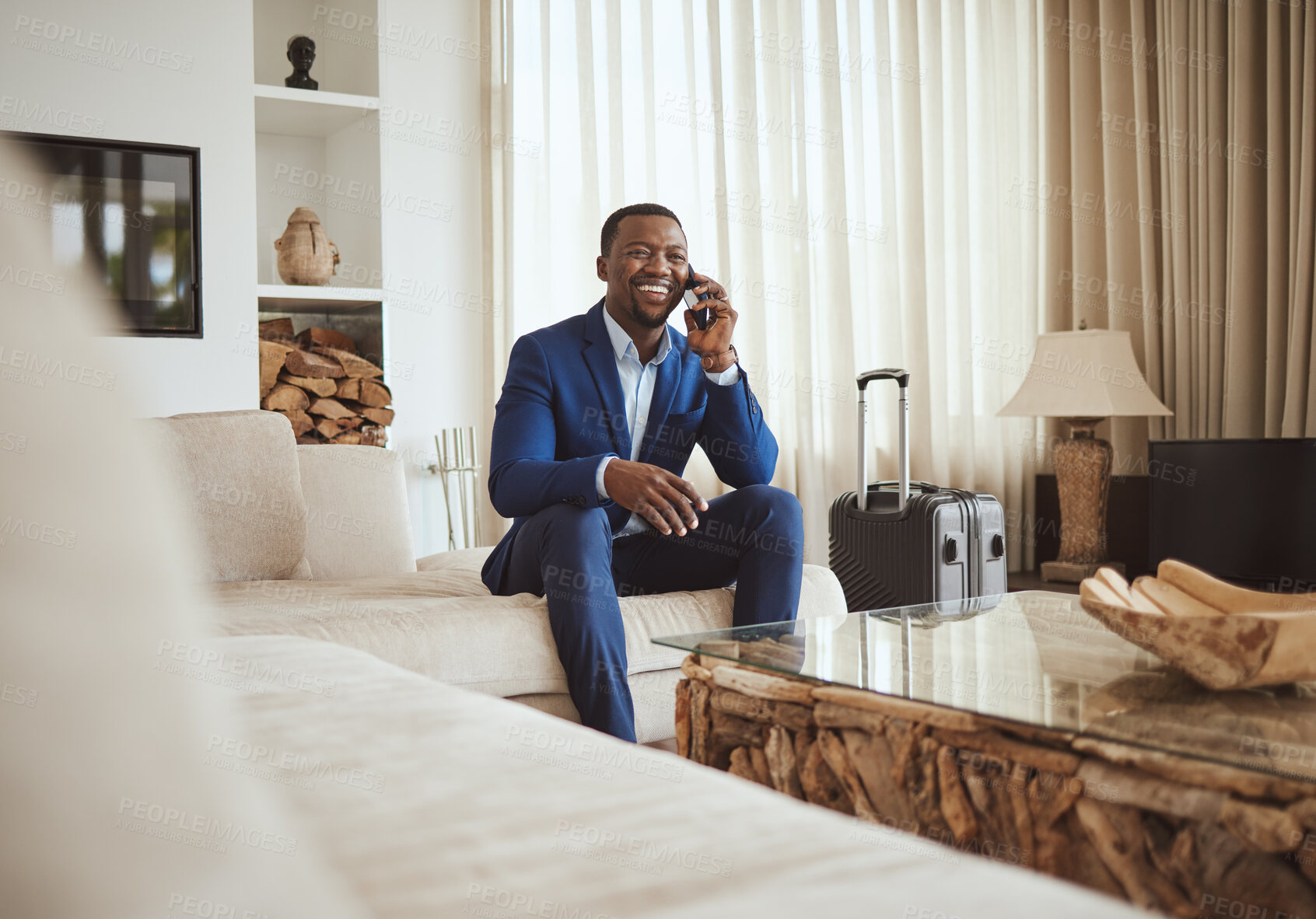 Buy stock photo Happy businessman in hotel, on smartphone call and business communication for work in Atlanta. Young black entrepreneur, listening to audio on cellphone and sitting on luxury sofa in living room