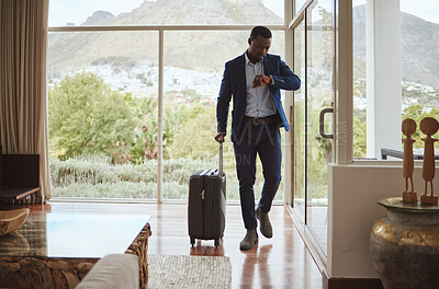 Buy stock photo Travel, business and black man reading time, notification check and watch with luggage at a hotel. Schedule, late and African businessman with a smart watch for communication during a trip for work