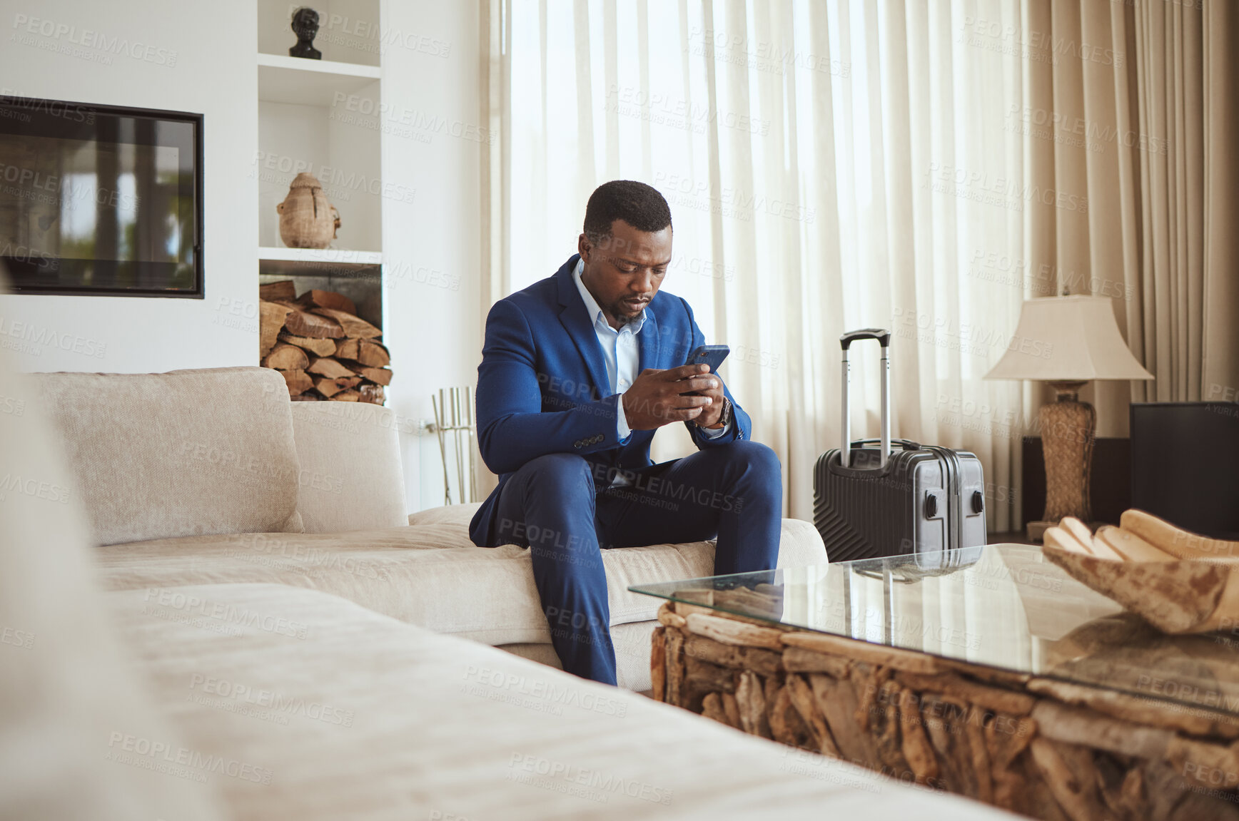 Buy stock photo African businessman on phone in hotel room, reading email on smartphone and corporate professional in Chicago. Black entrepreneur typing message, luxury accommodation in city and hospitality travel