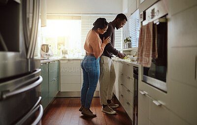 Buy stock photo Black couple, cooking and food in kitchen at home while together to cook healthy food for dinner or lunch. Happy woman helping her man at their house or apartment to prepare a meal with love and care