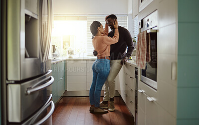 Buy stock photo Black couple, love and bonding in the kitchen at home with care and happiness in a marriage with commitment. Young man and woman together with a romantic hug while in their house or apartment