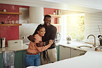 Black couple, happy home and love while together with care and happiness in a marriage with commitment and care. Young man and woman laughing while in the kitchen to bond in their house or apartment