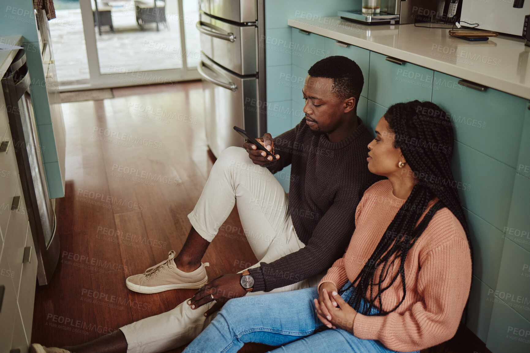 Buy stock photo Black couple, phone and kitchen floor while online on internet together for social media or ecommerce. Young man and woman talking while at home to bond, relax and use wifi for communication app