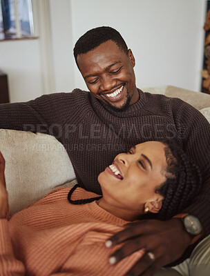 Buy stock photo Relax, laugh and together with a black couple bonding on a sofa in the living room of their home. Love, fun and humor with a man and woman joking, laughing or enjoying free time in the house