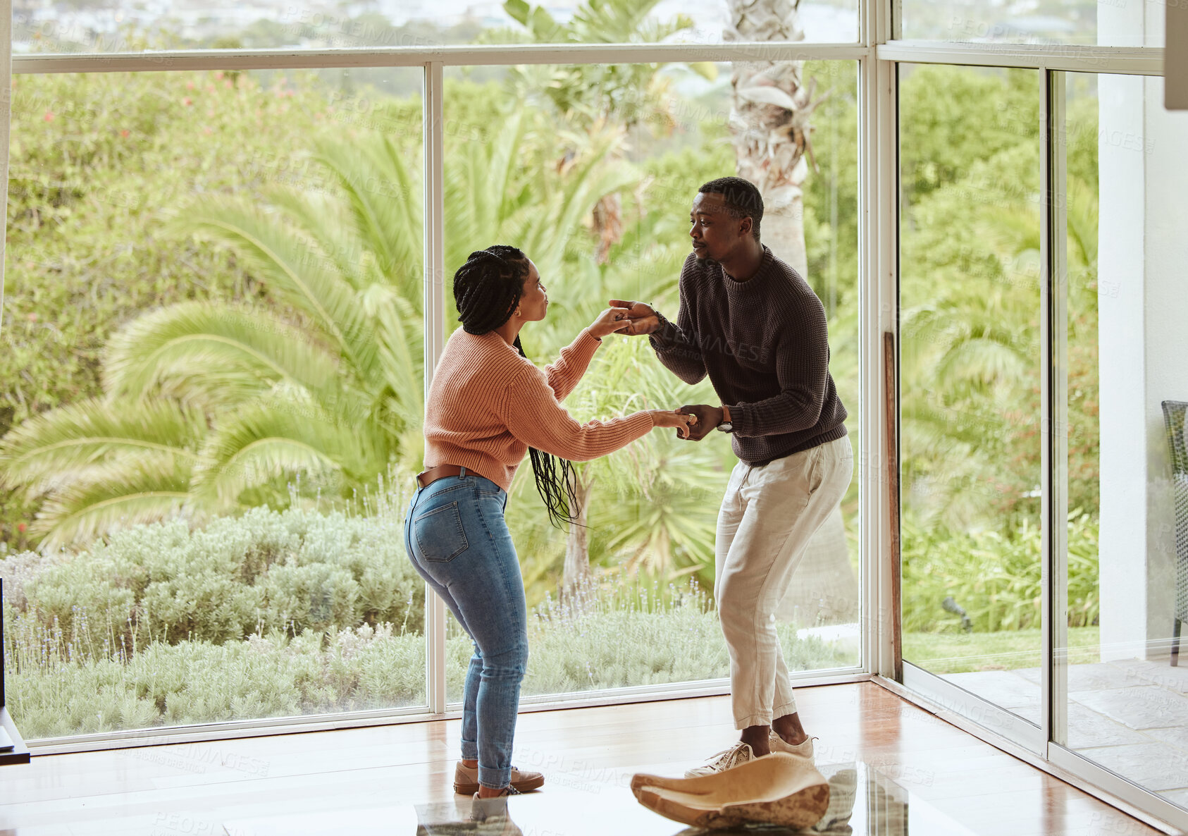 Buy stock photo Black couple, dancing and celebration in their new home with love while excited and happy in a healthy marriage. Young man and woman partner dance to celebrate in their house or apartment for fun