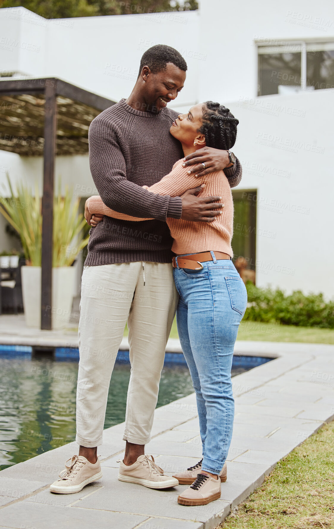 Buy stock photo Black couple, house and swimming pool property while outdoor for a hug, love and care while happy about real estate. Man and woman at their new home with pride and smile for mortgage loan approval