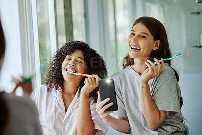 Buy stock photo Happy selfie, phone and friends brushing teeth for social media, live streaming routine and comic in the bathroom. Playful, smile and women with a flash mobile photo during morning dental care